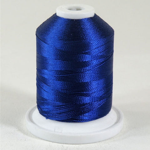 A Jamie Blue colored 1100 yd mini king spool of Robison-Anton 40wt Rayon that is vivid, high luster and super-smooth in appearance.